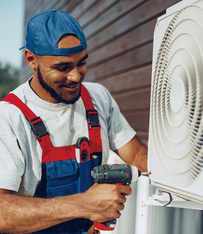 Repairman Installing Air Conditioner — Tulsa, OK — Dales & Lee’s Service Inc.